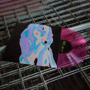 Anberlins Silverline Vinyl LP. album art depicts neon aura of two bodies holding each other. vinyl color is Clear Pink. The record is depicted against metal grates.