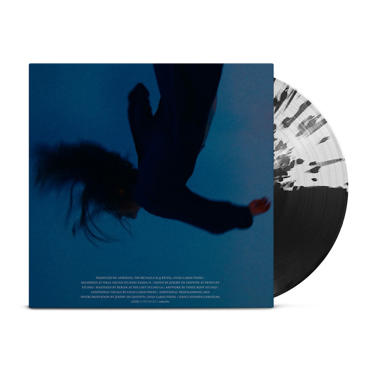 Anberlin "Convinced" vinyl. Cover is blue with a black, upside down figure falling. Vinyl is half clear with black splatters, half black.