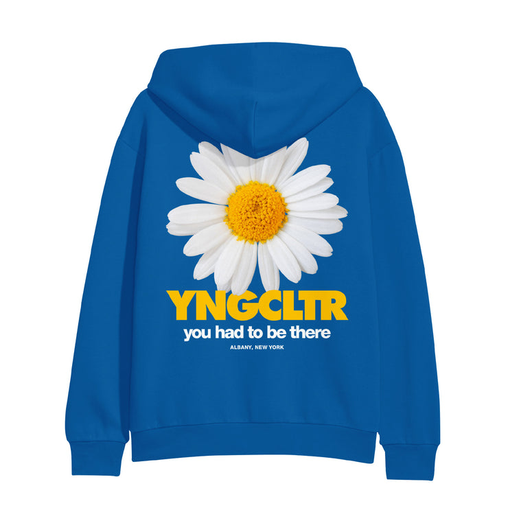 Large flower in the center of the back of the sweatshirt.  The flower has white pedals with a yellow center.  Below the flower reads YNGCLTR in yellow letters.  Below YNGCLTR reads YOU HAD TO BE THERE in smaller white letters.  Below the YOU HAD TO BE THERE reads ALBANY, NEW YORK in even smaller white letters.