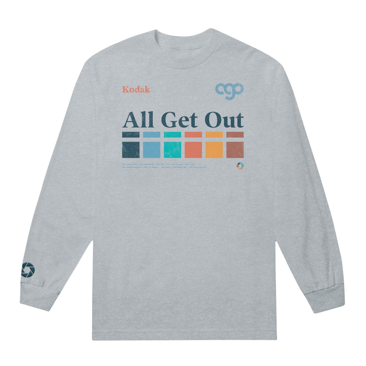 Ash colored long sleeve shirt with text across the chest that says "All Get Out". Below that is a color blocked rainbow design that runs horizontally. In the top corner of the chest, there is orange text that says Kodak. On the bottom of one sleeve there is a camera shutter design.