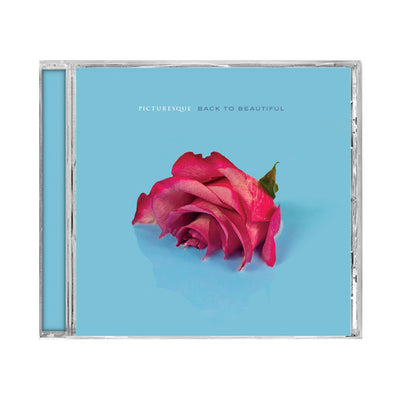 Square CD with a blue background and a red rose in the middle that is half submerged in the blue background. Above the rose there is text that reads, PICTURESQUE BACK TO BEAUTIFUL.