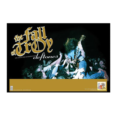 "The Fall of Troy - Deftones Tour" poster. Black poster pictured against a white background. On the poster is a picture of a guitarist jumping into an audience. To the left of him are the words "The Fall of Troy" in gold, with, in smaller white letters, the words "on tour this summer with," and in larger letters, "Deftones." On the bottom of the poster is a gold bar with no writing, and an album cover on the right inside it.