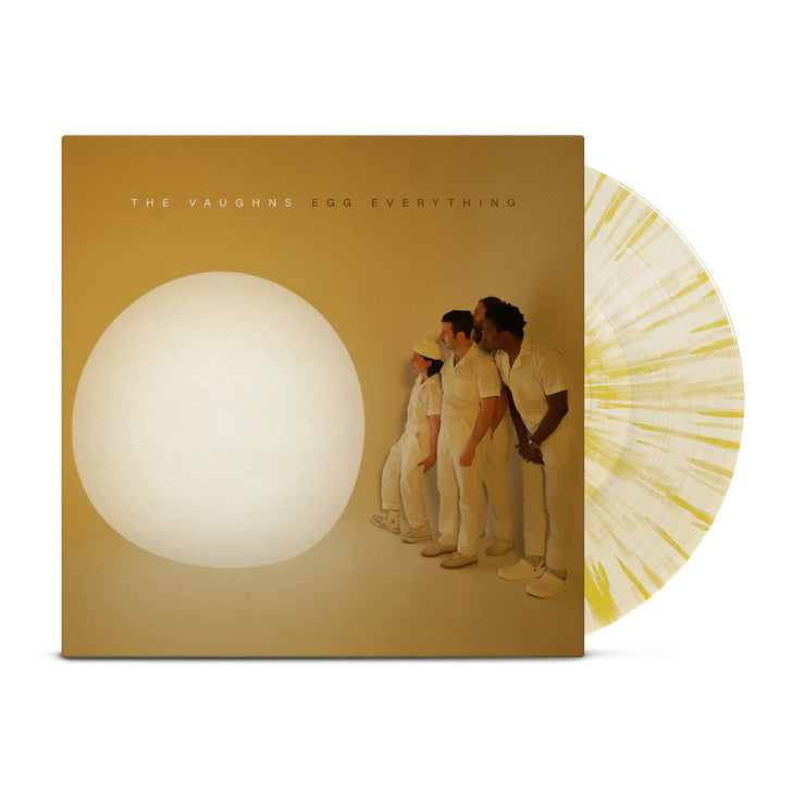The Vaughns - 'Egg Everything' vinyl. Pictured is a vinyl record against a white background. The album cover is mustard yellow, and it depicts four people in white jumpsuits staring at a large, white orb. Above them are the words "The Vaughns" in white, and "Egg Everything" in black.  There is a vinyl record to the side of the cover. It is a cream color with yellow splatter. 