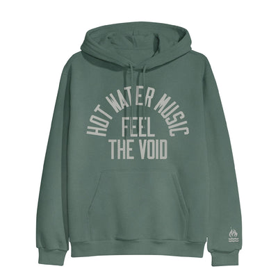 Alpine green colored pullover hoodie with HOT WATER MUSIC written across the chest in a half circle.  Below that there is text that says FEEL THE VOID. On the bottom of one sleeve, there is a drawing of a fire with two lines underneath it representing water. 