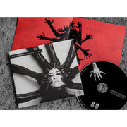 Square CD with an image of a woman's face. There are hands with black gloves on reaching at her face from all directions. In the top left corner there is text that says NIGHT VERSES INTO THE VANISHING LIGHT. To the right of the cover is a black CD with the same text written on it, with a hand reaching towards the center. There is also a red insert with hands reaching out from the center. All of them are laying on a granite surface.