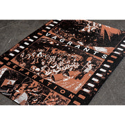 Screen printed film roll with images of live Vagrants performances. In between each of the three images there is text. Between the first two is white text that says VAGRANTS, and in between the second two is brown / orange text that says SEPARATION. All of the images have a brown / orange tint over them. The film roll is laying on top of a concrete surface.