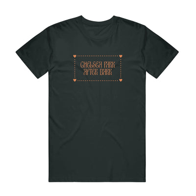 Black short sleeve shirt with "CHELSEA PARK AFTER DARK" written in orange lettering. Surrounding the lettering is orange dots in a rectangular shape with orange hearts in each corner.