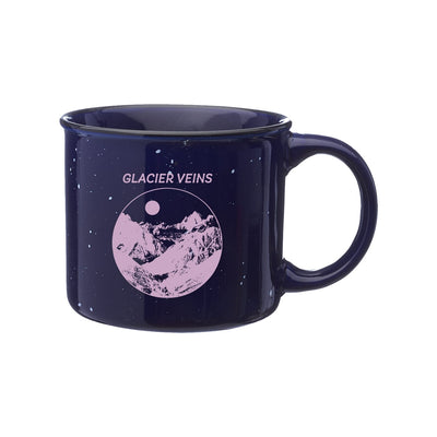 Navy coffee mug with text that says GLACIER VEINS in pink above a drawing of a mountain range with the moon above it.