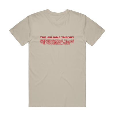 Sand colored short sleeve shirt with THE JULIANA THEORY written in red font across the chest. Below the text, there is a rectangle with a red design of leaves inside it.