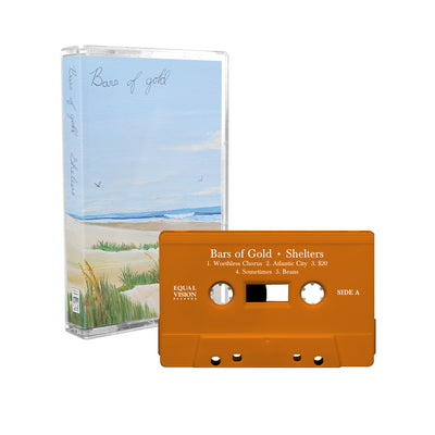 Cassette with album art of a beach with tall grass and birds flying in the sky. There is black cursive font that says BARS OF GOLD in the top left corner. There is an orange cassette next to the cover with text that says BARS OF GOLD and SHELTERS across the top.