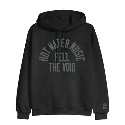 Black pullover hoodie with HOT WATER MUSIC written across the chest in a semi circle. Below that there is text that says FEEL THE VOID. On the bottom of one sleeve, there is a drawing of a fire with two lines underneath it representing water.