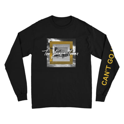 Black long sleeve shirt with CAN'T GO HOME written on the left sleeve in yellow. In the center of the shirt is a square with an image inside. The image is two people walking in front of a billboard sign that says CAN'T GO HOME. On top of that image is THE JULIANA THEORY written in white text.
