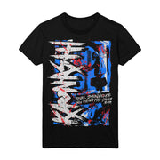 Black short sleeve shirt with Kaonashi written vertically on the left hand side in white font. The background is blue, red, black, and white splattered. There is smaller scratchy text towards the bottom right, also printed in white.