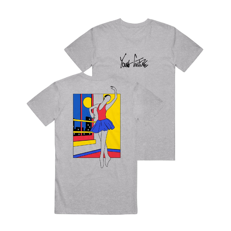 Athletic grey short sleeve shirt with YOUNG CULTURE written across the chest in black lettering. On the back of the shirt is a drawing of a ballerina in red blue and yellow. She is dancing in a room, and outside the window are tall buildings and the moon in the sky.