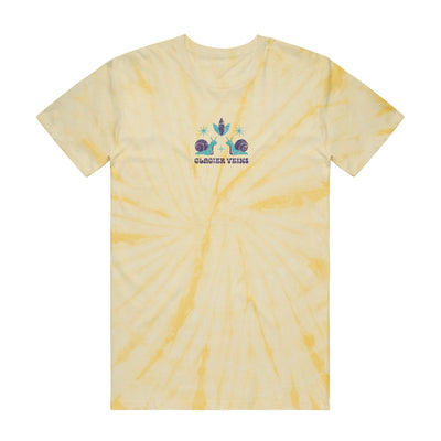 Yellow tie dye short sleeve shirt with GLACIER VEINS written in purple writing on the chest. Above that is a drawing of two snails facing each other, with a flower on top of them.