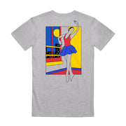 Back of the short sleeve shirt is a drawing of a ballerina in red blue and yellow. She is dancing in a room, and outside the window are tall buildings and the moon in the sky.