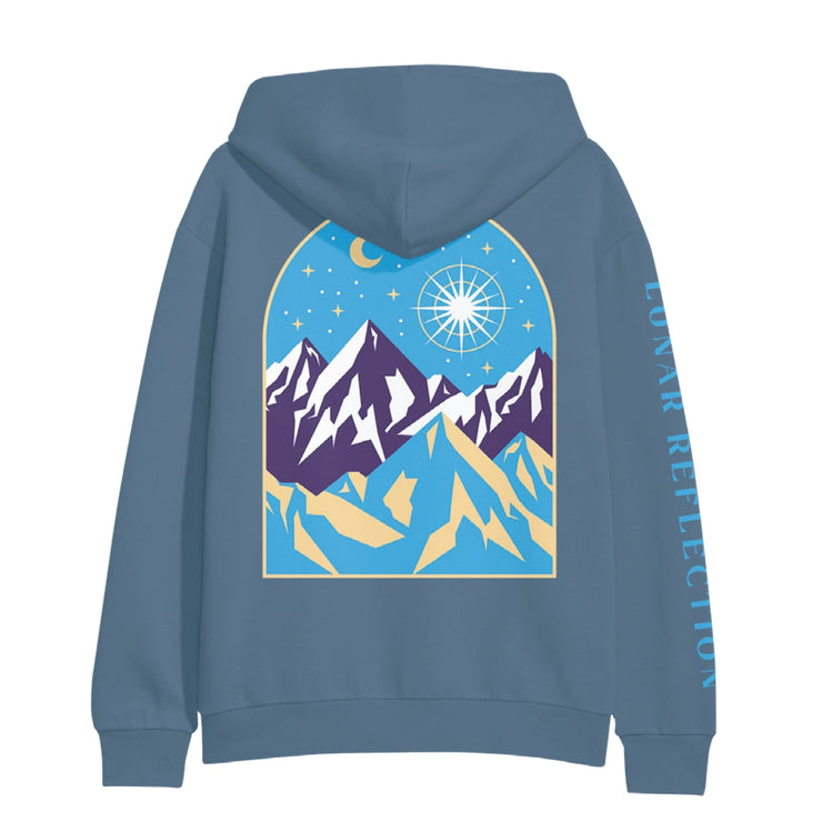 Back of indigo colored hoodie with a drawing of mountains and a night sky. There is a star drawn brightly shining next to the moon above a mountain range. 