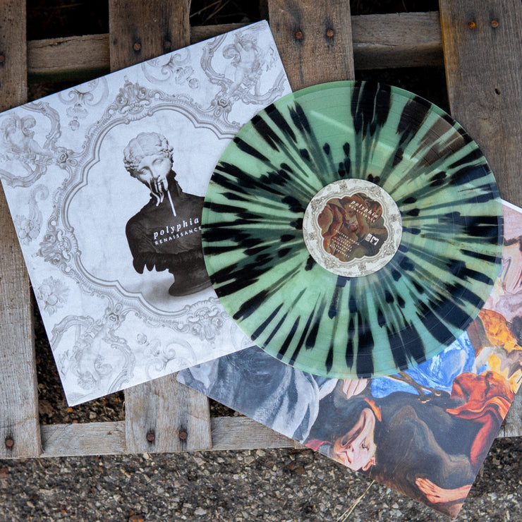 Square vinyl with a white background that depicts elegant architectural engravings. There is a shoulders up statue of a woman in the center of the vinyl. There is text on the chest of the woman statue that says POLYPHIA and below that text RENAISSANCE. Layed on top of the Vinyl cover is the vinyl itself which is colored black and light blue. Underneath both the vinyl cover and the vinyl is the vinyl insert that has abstract art on it and underneath that is a wood pallet.