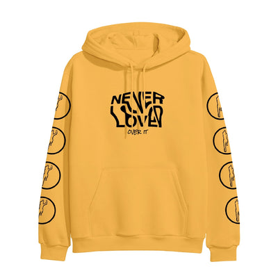 Gold colored pullover hoodie with NEVER LOVED written across the chest in wavy black font. Below that there is smaller black text that says OVER IT. On both sleeves there are cutouts of a person jumping in the air, surrounded by a circle.