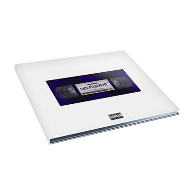 White square CD that depicts an above image of an old vhs tape.  The VHS tape is the color purple and has text in the front of the vhs tape that reads ENTERTAINMENT.
