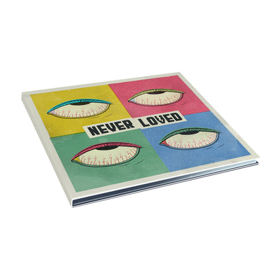 Square CD with NEVER LOVED written in the center in black font over a white background. There are four smaller squares in yellow, red, green, and blue, each with its contrasting color's eyeball drawn inside. 