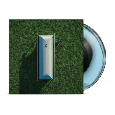 Vinyl case with an image of a grey coffin on top of grass.  The vinyl sticking out of the side of the case is a blue and black mix.