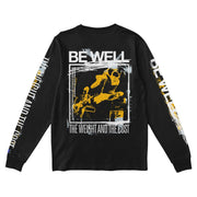 Back of black long sleeve shirt with BE WELL written in large font. Below that there is a drawing of someone playing guitar. Below the image is more white text that says THE WEIGHT AND THE COST.