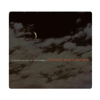 Cd cover that shows a dark night sky with clouds across the image.  There is text that reads In Keeping Secrets of Silent Earth: 3 and Coheed and Cambria as well.  There is a white border around all of this. 