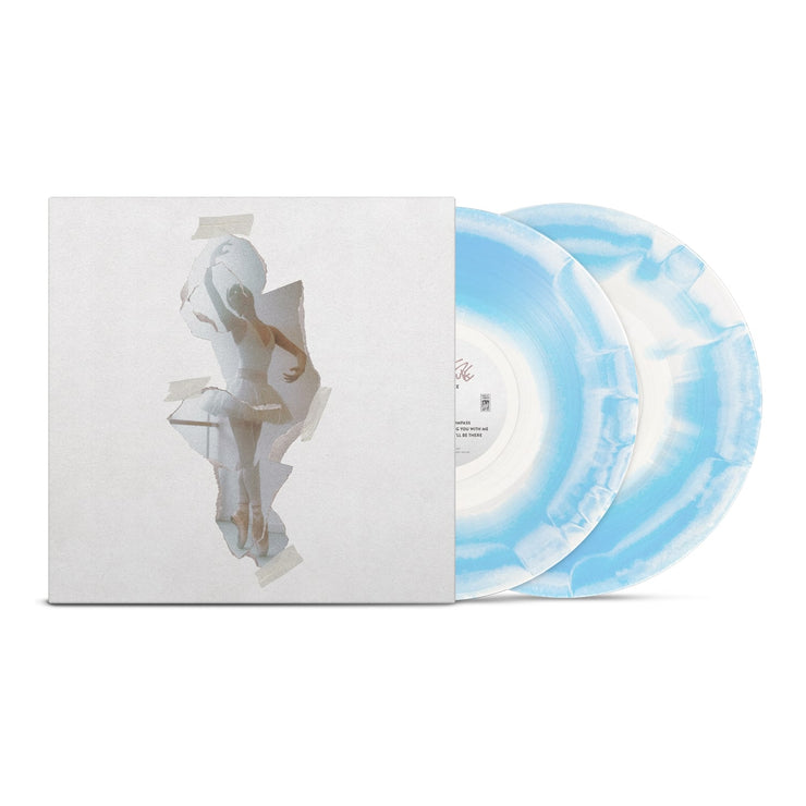 White vinyl jacket with a "taped" on image of a ballerina in the center. To the right of the vinyl jacket is a blue and white mix vinyl.