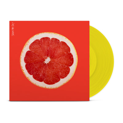 Bright orange colored vinyl jacket with an image of the inside of a grapefruit. In the top left corner there is vertical white text that says SAVES THE DAY. Peeking out of the jacket is a yellow vinyl.