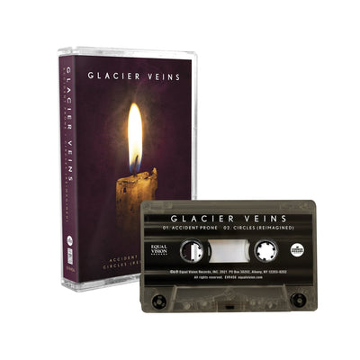 Cassette case with cassette on right hand side. Cassette case is a close up photo of a candle stick with a single flame. The top of the case says GLACIER VEINS in white lettering. On the side of the case, it says GLACIER VEINS in the same design. Cassette to the right of the case is black with a smokey tint. GLACIER VEINS written on top in white.