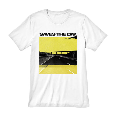 White short sleeve shirt with a yellow tinted image of a highway. There is an overpass and a cloud in the top corner. Above the image is black text that says SAVES THE DAY.