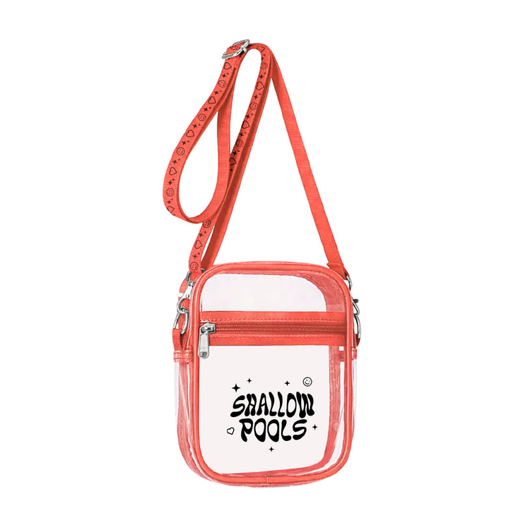 Shallow Pools I Think About It All The Time clear Sling Bag. a clear side fanny pack type bag with the text "shallow pools" printed in black on one side. the bag has a red sling and trim.